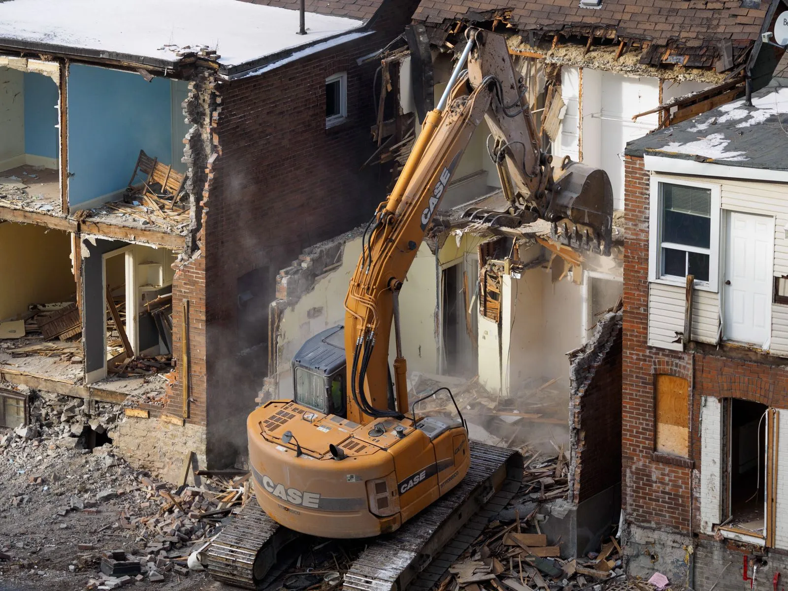 Excavator demolishing a building at a Bailey Demolition job site in the Omaha metro